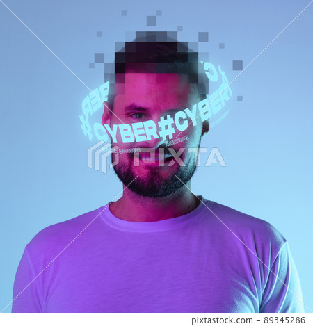 Contemporay artwork. Young man with pixel head elements and neon lettering around isolated over blue background in neon light Contemporay artwork. Young man with pixel head elements and neon lettering around isolated over blue background in neon light 89345286