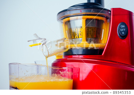 raw food diet concept oranges and juicemachine in white background raw food diet concept oranges and juicemachine in white background 89345353