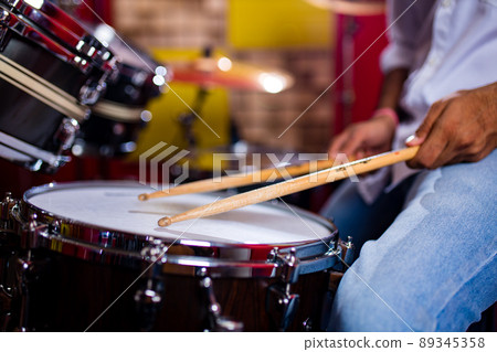 indian man playing the drums sticks close-up in recording studio indian man playing the drums sticks close-up in recording studio 89345358