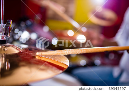 indian man playing the drums sticks close-up in recording studio indian man playing the drums sticks close-up in recording studio 89345597
