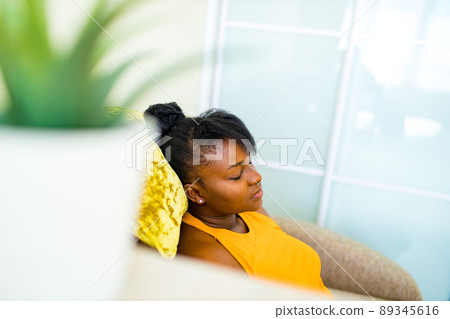 latin brazilian woman feeling calm relaxing in living room on meditation latin brazilian woman feeling calm relaxing in living room on meditation 89345616