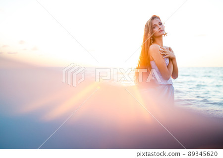 mermaid myth in sunset on beach shore with fish star shells pearls earrings jewelry 89345620