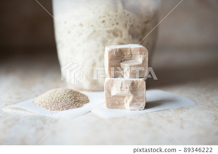 Instant and fresh raw yeast and sourdough in a jar. Natural leavening agents for baking. Close up. Instant and fresh raw yeast and sourdough in a jar. Natural leavening agents for baking. Close up. 89346222