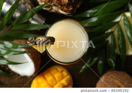 Pina colada cocktail and ingredients on wooden background 89346392
