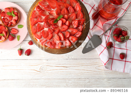 Concept of tasty food with strawberry tart on white wooden background 89346516