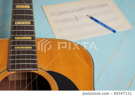 guitar music sheet and pencil on wooden table guitar music sheet and pencil on wooden table 89347131