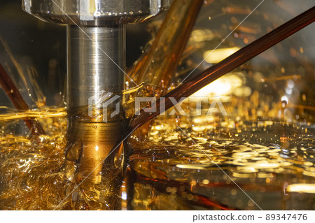 Close-up scene the CNC milling machine cutting the mold parts with oil coolant method. Close-up scene the CNC milling machine cutting the mold parts with oil coolant method. 89347476