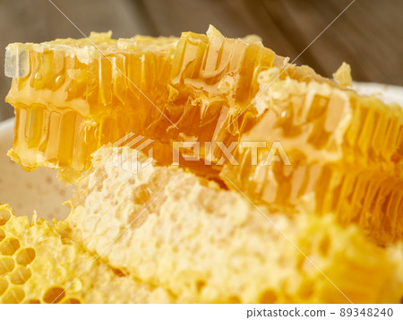 honey in honeycomb, close-up, on white ceramic plate, on wooden rustic table, honey in honeycomb, close-up, on white ceramic plate, on wooden rustic table, 89348240