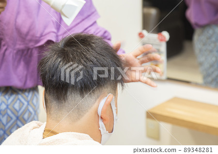 Children drying their hair in a beauty salon 89348281