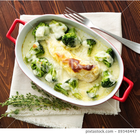 Chicken fillet baked with broccoli in bechamel sauce on dark wooden table. Healthy food Chicken fillet baked with broccoli in bechamel sauce on dark wooden table. Healthy food 89348447