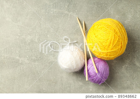 Yarn balls and knitting needles on light gray background Yarn balls and knitting needles on light gray background 89348662