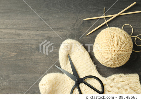 Concept of knitting with yarn ball on gray wooden table Concept of knitting with yarn ball on gray wooden table 89348663