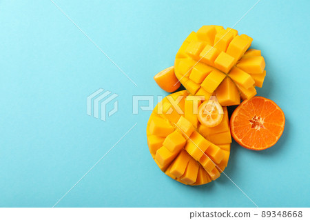 Ripe mango and orange on blue background 89348668