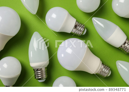Energy saving bulbs on green background, top view Energy saving bulbs on green background, top view 89348771