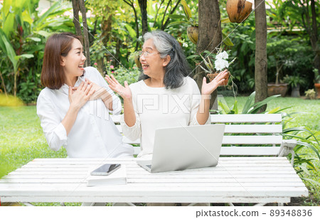Asian daughter teaching old elderly woman use online Social media in computer laptop after retirement. Concept of Learning technology and adaptation of the elderly Asian daughter teaching old elderly woman use online Social media in computer laptop after retirement. Concept of Learning technology and adaptation of the elderly 89348836