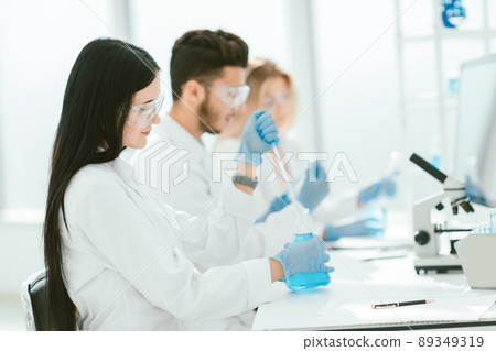 close up.modern woman sitting with colleagues at the laboratory close up.modern woman sitting with colleagues at the laboratory 89349319