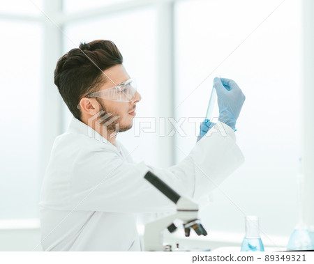 close up. scientist with a medical tube standing in the lab close up. scientist with a medical tube standing in the lab 89349321