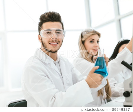 man scientist holding a flask of liquid for the experiment 89349327