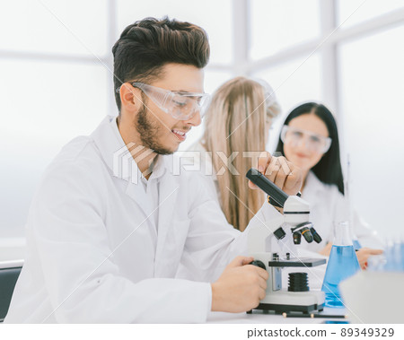 scientists biologists sitting at the laboratory table. scientists biologists sitting at the laboratory table. 89349329
