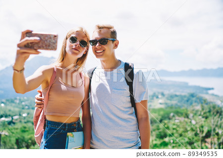 Couple of travelers taking selfie on smartphone Couple of travelers taking selfie on smartphone 89349535