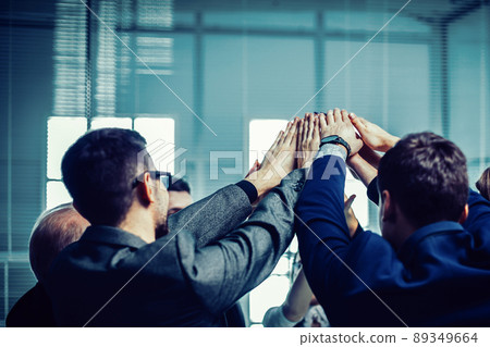 close up. a group of corporate employees showing their unity close up. a group of corporate employees showing their unity 89349664