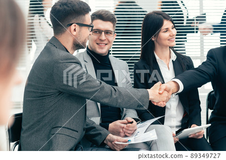 boss shaking hands with an employee during a work meeting boss shaking hands with an employee during a work meeting 89349727