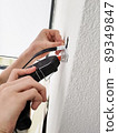 Male hands with glue gun - works with wiring 89349847