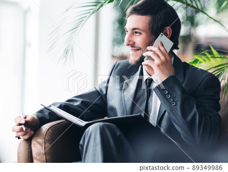 Confident businessman in office talking the phone. 89349986