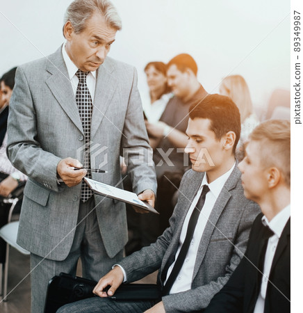Business meeting - manager discussing work with his colleagues Business meeting - manager discussing work with his colleagues 89349987