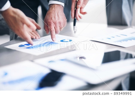 business team discussing financial charts on a workplace business team discussing financial charts on a workplace 89349991