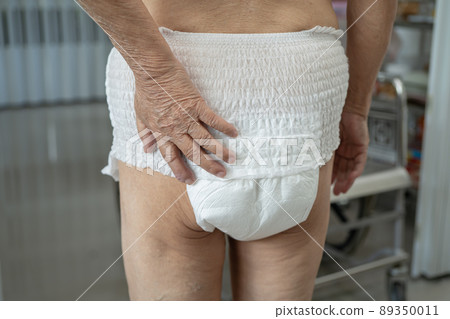 Asian senior or elderly old lady woman patient wearing incontinence diaper in nursing hospital ward, healthy strong medical concept. 89350011