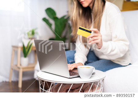 Woman shopping with laptop and credit card Woman shopping with laptop and credit card 89350157