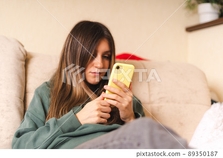 Woman with laptop and phone Woman with laptop and phone 89350187