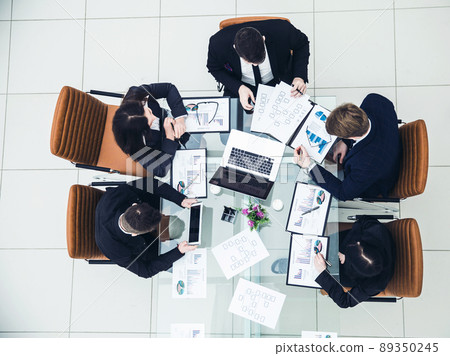 successful business team discussing a new marketing schemes in the workplace 89350245