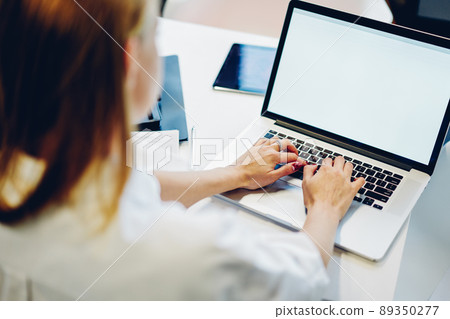 Faceless female freelancer working on computer in workplace 89350277