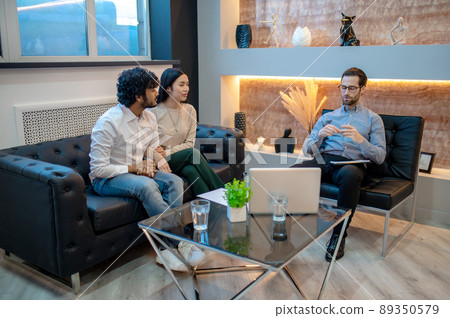 Young man and his female companion sitting in the psychologist office 89350579