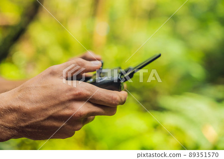 Hands of a man with a control panel for drones 89351570