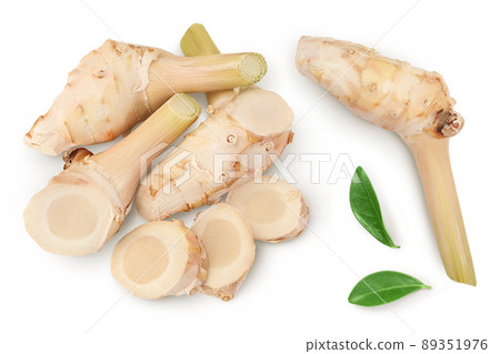 Fresh galangal root with slices isolated on white background with clipping path and full depth of field. Top view. Flat lay 89351976
