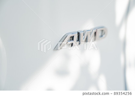 The inscription on the white car door AWD. all wheel drive The inscription on the white car door AWD. all wheel drive 89354256