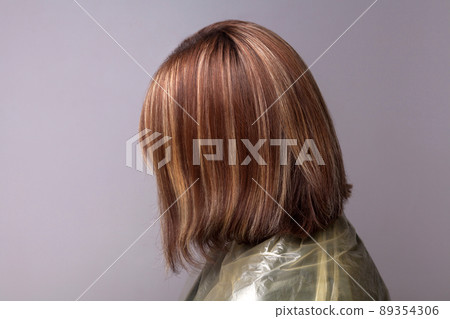 Profile side view of woman with highlighted brown hairs. indoor studio shot, isolated on gray background. Profile side view of woman with highlighted brown hairs. indoor studio shot, isolated on gray background. 89354306