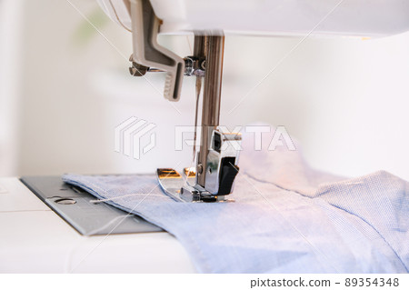 A man sews clothes on sewing machine. Hobbies 89354348