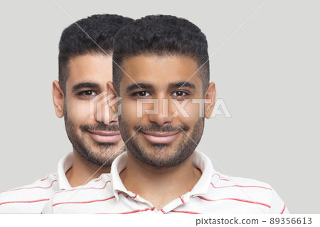 Closeup portrait of young brunette bearded man with different facial skin tone, darker and lighter, looking and smiling. before and after, sunbath, treatment and solarium concept. indoor studio shot. Closeup portrait of young brunette bearded man with different facial skin tone, darker and lighter, looking and smiling. before and after, sunbath, treatment and solarium concept. indoor studio shot. 89356613