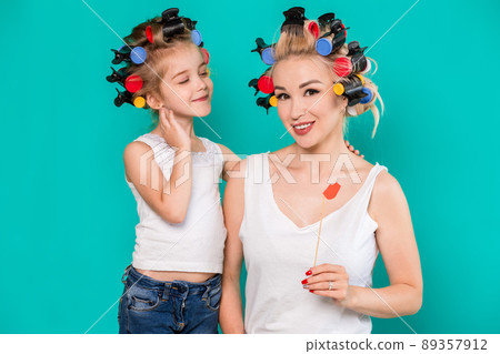 Funny family Mother and her child daughter girl with a paper accessories. 89357912