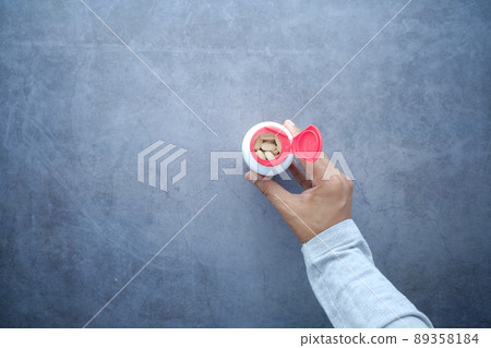 top view of young man hand holding medicine pill container top view of young man hand holding medicine pill container 89358184