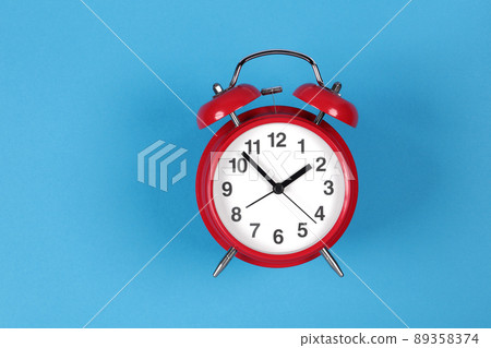 Retro red clock on a blue background 89358374