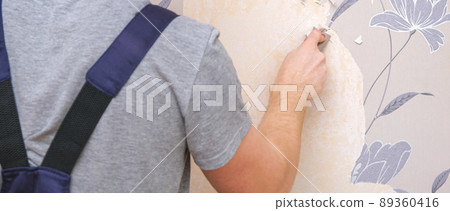 Removing old wallpaper with a spatula and a 89360416