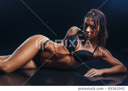 Sexy brunette fitness woman posing wet over... - Stock Photo [89362042] -  PIXTA
