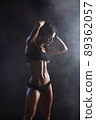 Female fitness model posing on black background 89362057