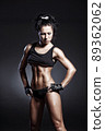 Female fitness model posing on black background 89362062