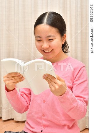 A girl reading a book A girl reading a book 89362148